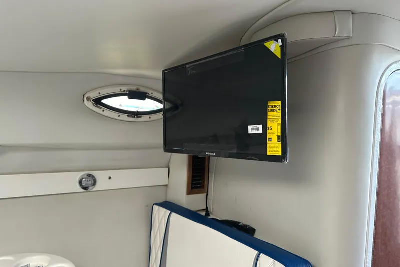Slide: The Image of Interior of 2002 Wellcraft 2600 Martinique boat with mounted TV and porthole window. - 11