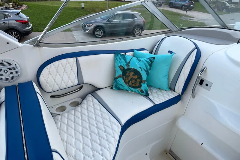 Slide: The Image of Interior of 2002 Wellcraft 2600 Martinique boat with blue and white seating and decorative pillows. - 3