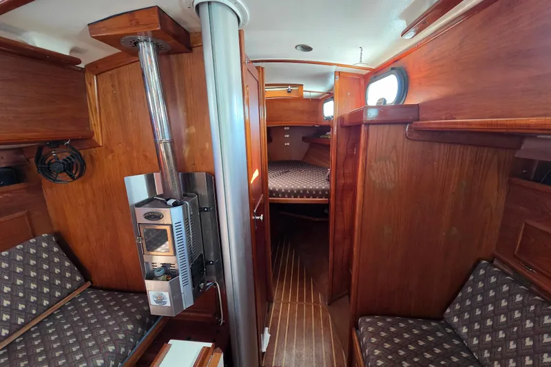 Slide: The Image of Interior of 1982 Cape Dory 33 sailboat with wood paneling and cozy seating. - 10
