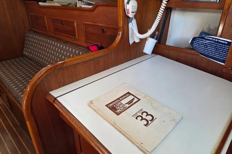 Slide: The Image of Interior of 1982 Cape Dory 33 yacht with owner's manual on table. - 11
