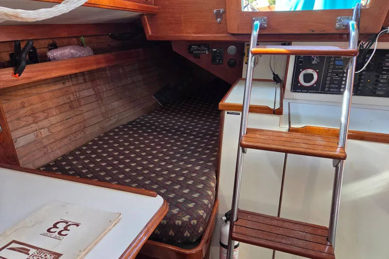 Slide: The Image of Interior of a 1982 Cape Dory 33 sailboat with wooden ladder and cozy berth. - 13