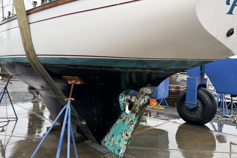 Slide: The Image of 1982 Cape Dory 33 sailboat on stands, showing hull and rudder details. - 15