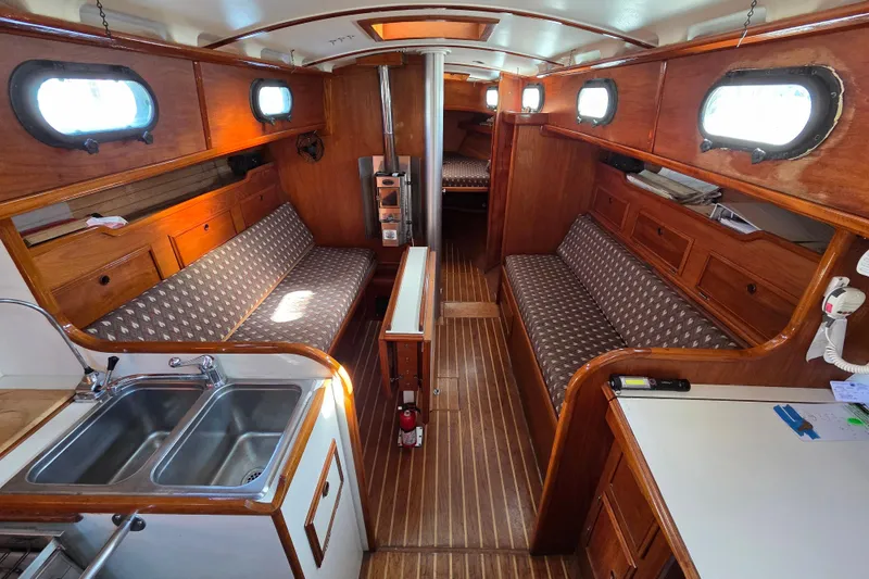 Slide: The Image of Interior of 1982 Cape Dory 33 sailboat with wood finish and cozy seating. - 7