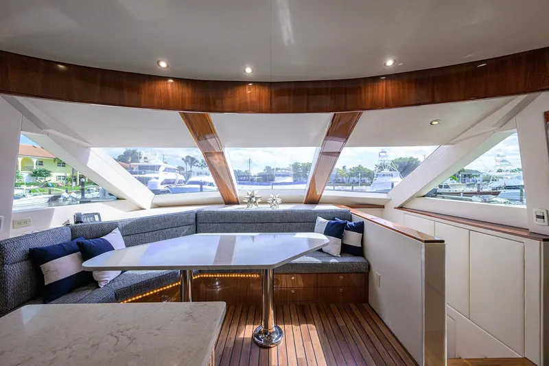 Slide: The Image of Luxurious interior of 2009 Hatteras Enclosed Bridge yacht with panoramic windows and elegant seating. - 12