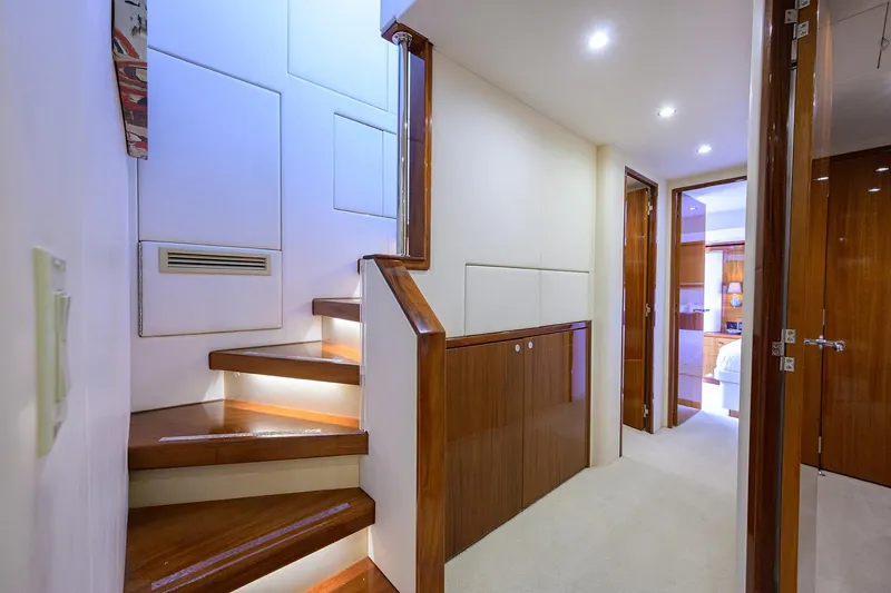 Slide: The Image of Interior of 2009 Hatteras Enclosed Bridge yacht with wooden stairs and modern lighting. - 14