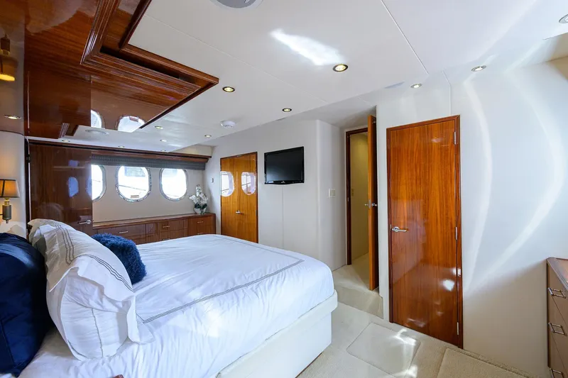Slide: The Image of Luxurious bedroom interior on 2009 Hatteras Enclosed Bridge yacht with elegant wood finishes. - 17