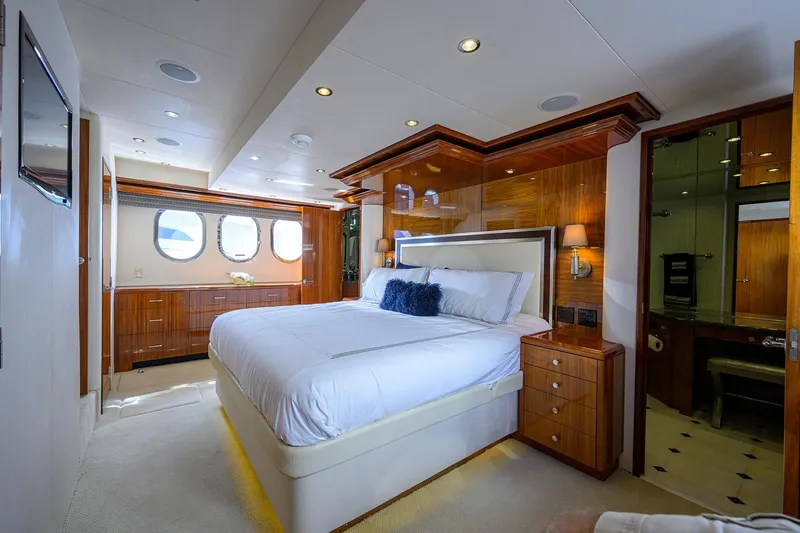 Slide: The Image of Luxurious bedroom interior on 2009 Hatteras Enclosed Bridge yacht, featuring elegant wood finishes. - 18