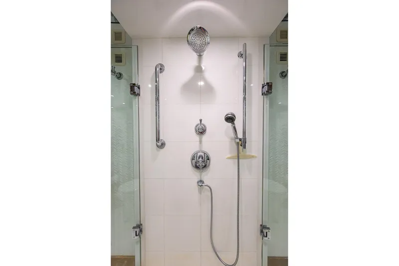 Slide: The Image of Luxury shower in 2009 Hatteras Enclosed Bridge yacht, featuring modern fixtures and glass doors. - 22