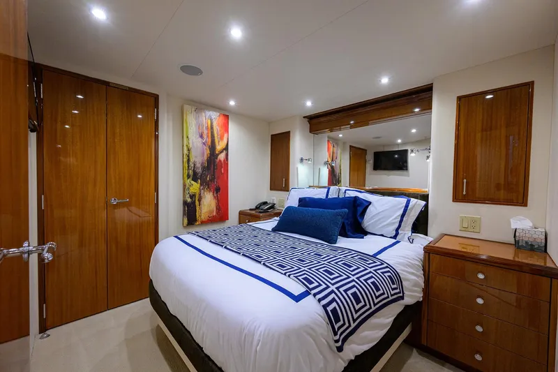 Slide: The Image of Luxurious bedroom interior on 2009 Hatteras Enclosed Bridge yacht with modern decor. - 23