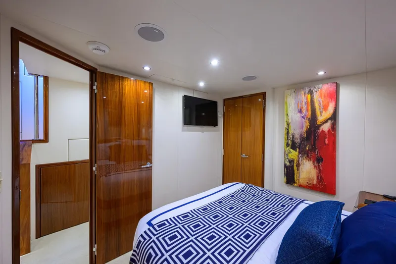 Slide: The Image of Luxurious bedroom interior on 2009 Hatteras Enclosed Bridge yacht with modern decor. - 24