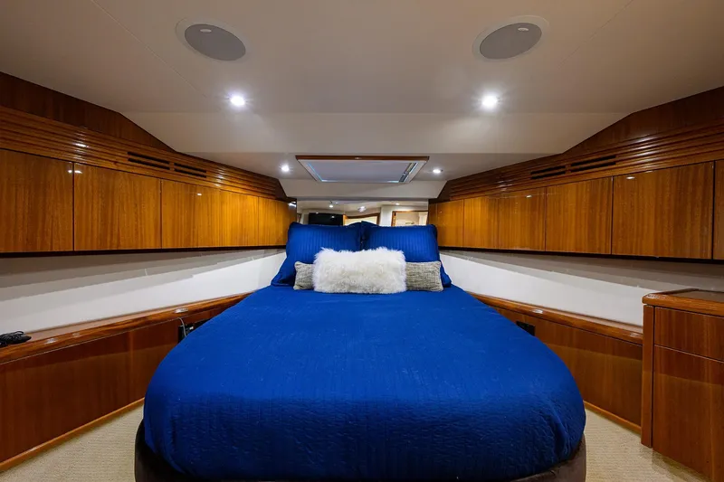 Slide: The Image of Luxurious cabin interior of 2009 Hatteras Enclosed Bridge yacht with blue bedding. - 26