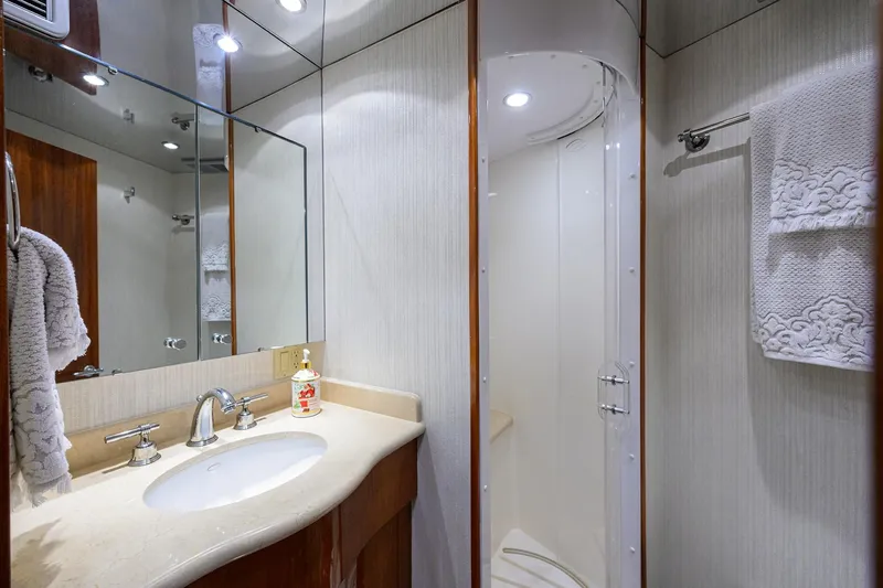 Slide: The Image of Luxurious bathroom in 2009 Hatteras Enclosed Bridge yacht with elegant fixtures and shower. - 29