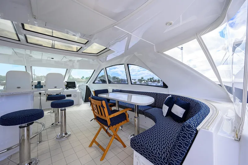 Slide: The Image of Luxurious 2009 Hatteras Enclosed Bridge yacht interior with seating and navigation area. - 32