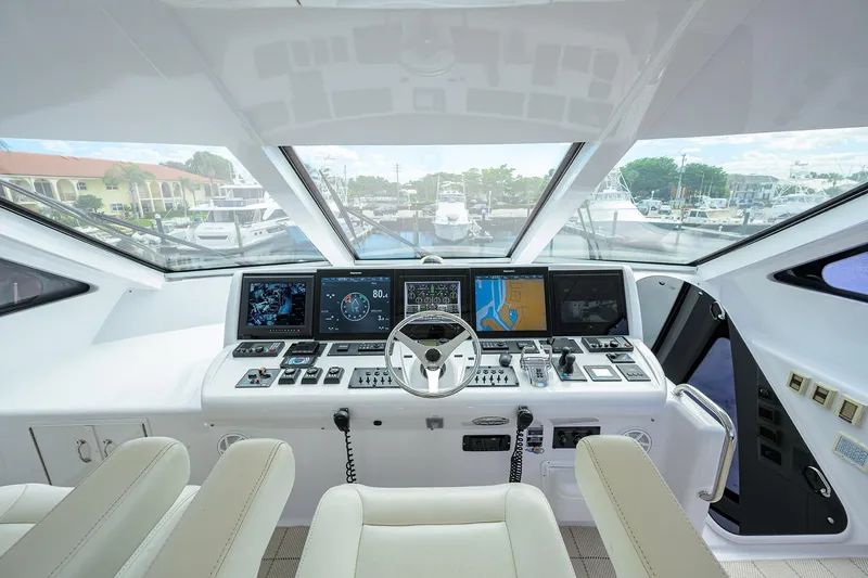 Slide: The Image of 2009 Hatteras Enclosed Bridge yacht helm with advanced navigation systems and panoramic view. - 35