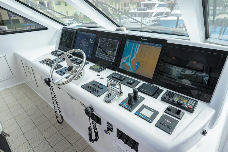 Slide: The Image of 2009 Hatteras Enclosed Bridge yacht helm with advanced navigation and control systems. - 36