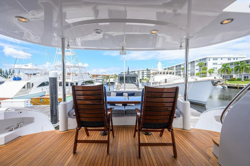 Slide: The Image of 2009 Hatteras Enclosed Bridge yacht with wooden deck and marina view. - 47