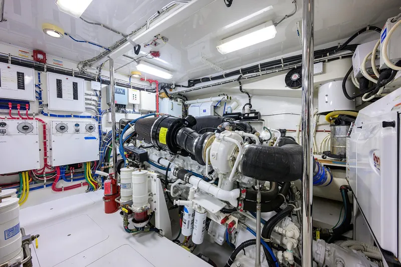 Slide: The Image of Engine room of 2009 Hatteras Enclosed Bridge yacht, showcasing complex machinery and wiring. - 51