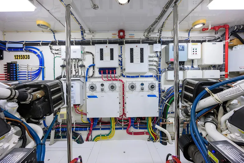 Slide: The Image of Engine room of 2009 Hatteras Enclosed Bridge yacht, showcasing complex wiring and machinery. - 52