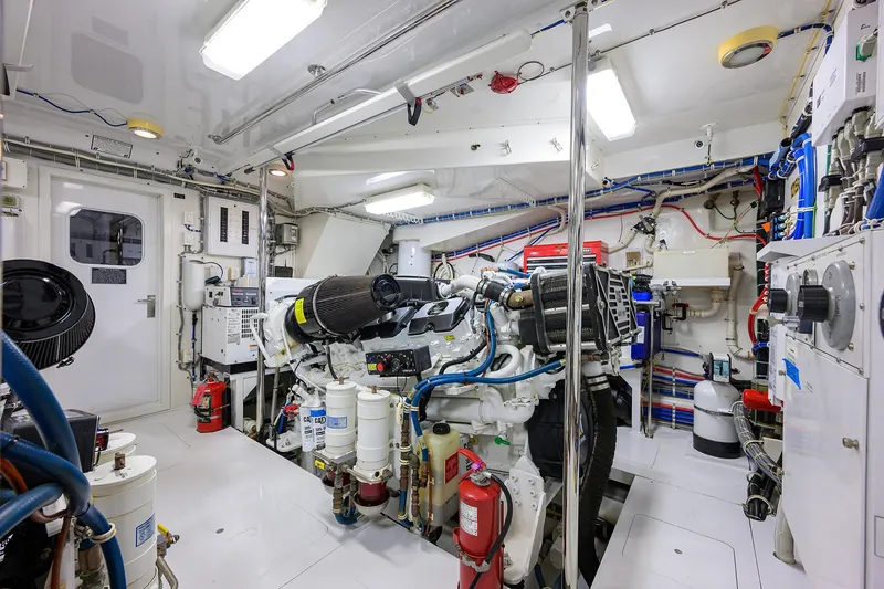 Slide: The Image of Engine room of 2009 Hatteras Enclosed Bridge yacht, featuring complex machinery and equipment. - 53