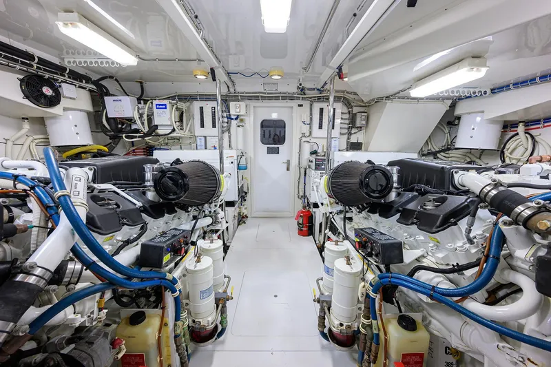 Slide: The Image of Engine room of 2009 Hatteras Enclosed Bridge yacht, featuring dual engines and complex wiring. - 54