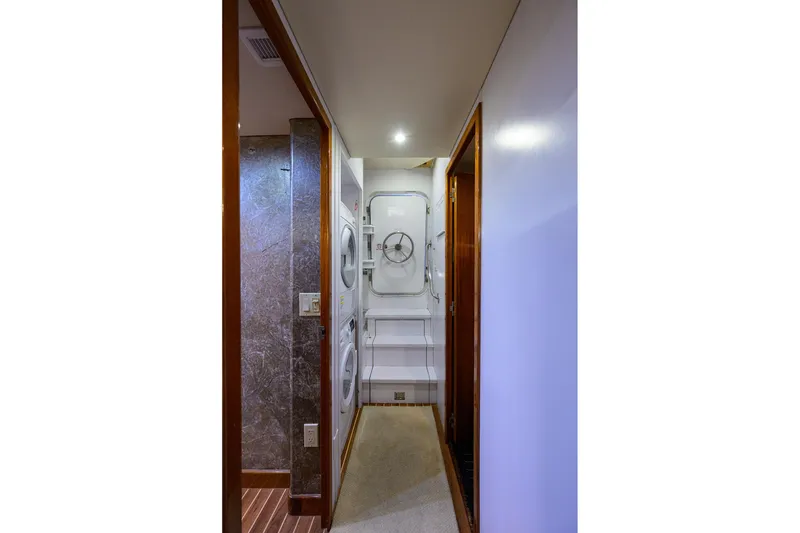 Slide: The Image of Interior hallway of 2009 Hatteras Enclosed Bridge yacht with washer and dryer. - 55