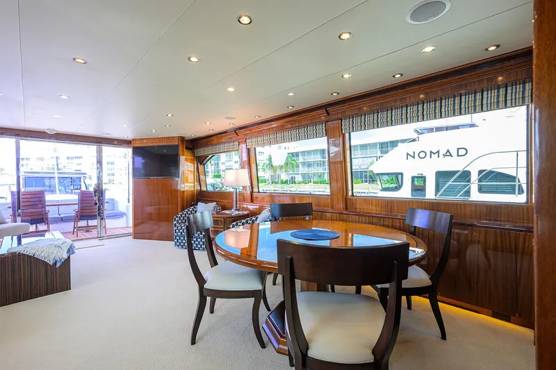 Slide: The Image of Luxurious interior of 2009 Hatteras Enclosed Bridge yacht with elegant dining area. - 6