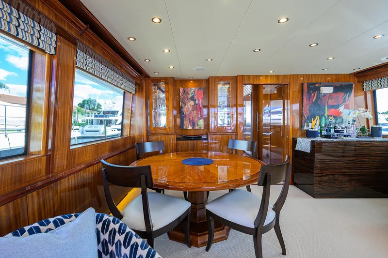 Slide: The Image of Luxurious 2009 Hatteras Enclosed Bridge yacht interior with elegant dining area and modern decor. - 7