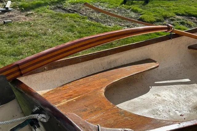 Slide: The Image of 1974 Jarvis Newman rowing/sailing dinghy with wooden oars on grassy background. - 4