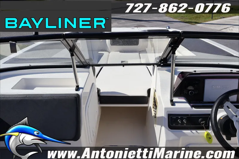 Slide: The Image of 2023 Bayliner DX 2000 boat interior with steering wheel and dashboard, Antonietti Marine branding. - 14