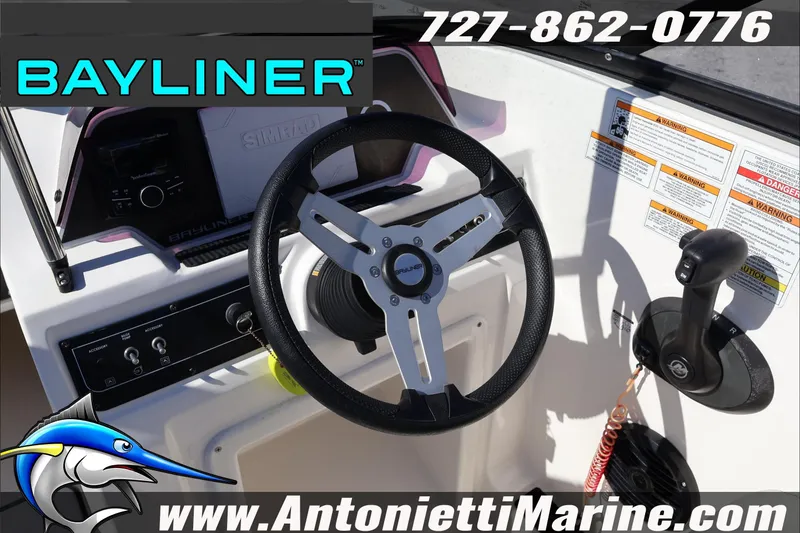 Slide: The Image of 2023 Bayliner DX 2000 boat steering console with controls and branding. - 17