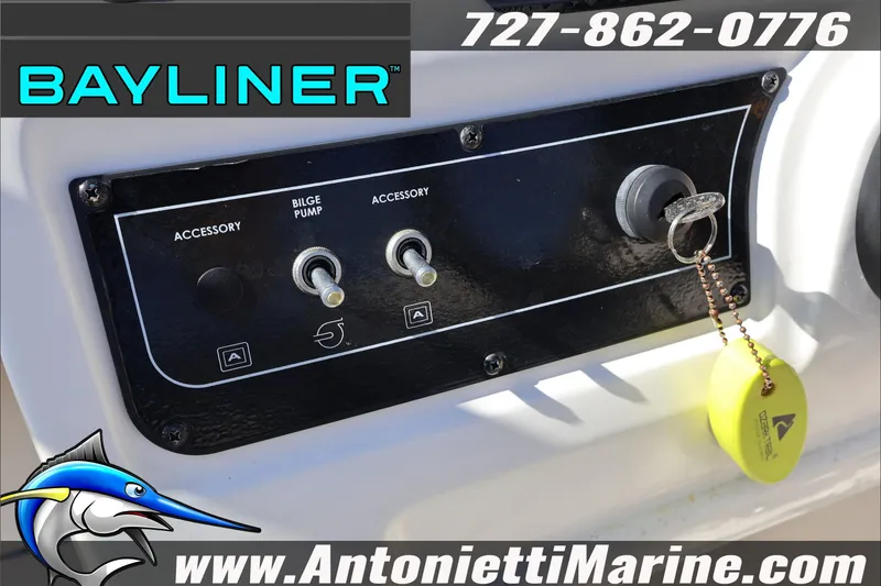 Slide: The Image of 2023 Bayliner DX 2000 control panel with accessory switches and ignition key. - 18