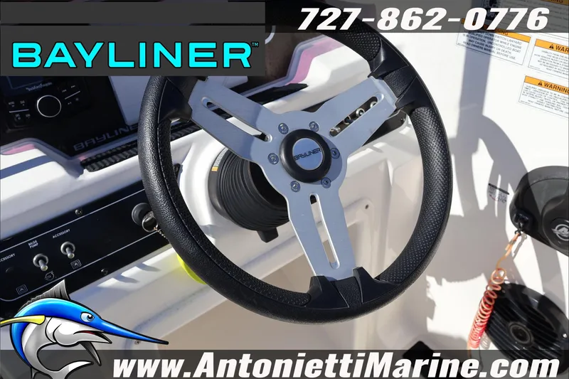Slide: The Image of Steering wheel of 2023 Bayliner DX 2000 boat, featuring control panel and branding. - 22