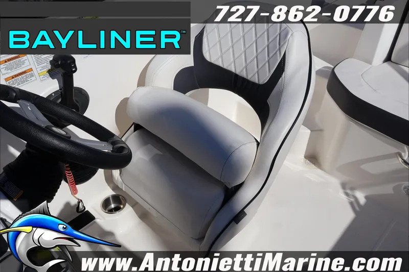 Slide: The Image of 2023 Bayliner DX 2000 boat interior with steering wheel and cushioned seat. - 23