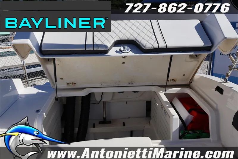 Slide: The Image of 2023 Bayliner DX 2000 boat storage compartment open, showcasing interior space. - 27