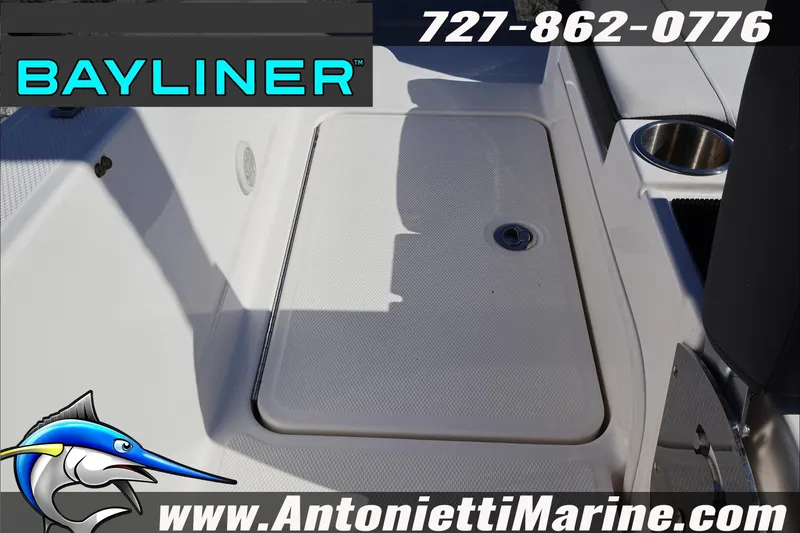 Slide: The Image of 2023 Bayliner DX 2000 boat deck with storage compartment and cup holder. - 29