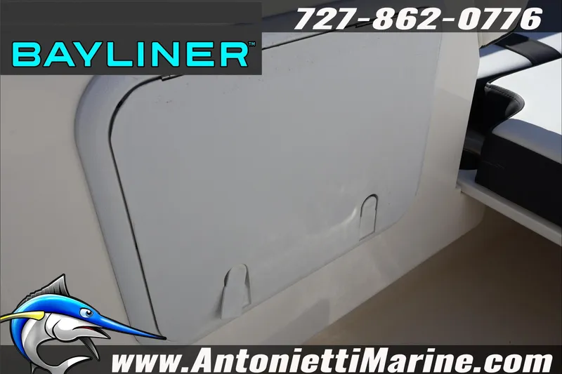 Slide: The Image of Bayliner DX 2000 boat storage compartment, 2023 model, with contact and website details. - 34