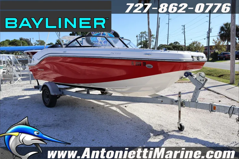Slide: The Image of 2023 Bayliner DX 2000 boat in red on a trailer at Antonietti Marine. - 4