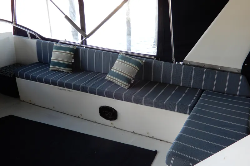 Slide: The Image of 1989 Jefferson 46 Sundeck interior with striped seating and cushions. - 15