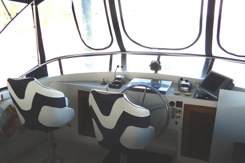 Slide: The Image of Helm of 1989 Jefferson 46 Sundeck yacht with modern navigation equipment and stylish seating. - 18