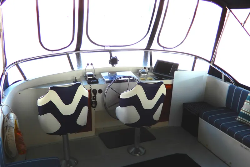 Slide: The Image of 1989 Jefferson 46 Sundeck boat interior with helm, modern seating, and navigation equipment. - 19