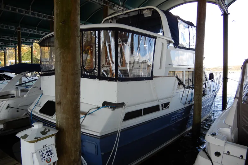 Slide: The Image of 1989 Jefferson 46 Sundeck yacht docked in a covered marina. - 2