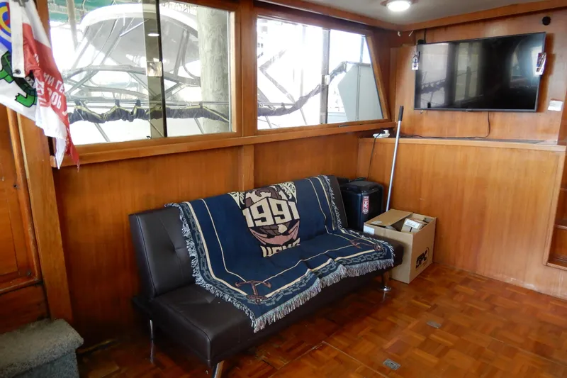 Slide: The Image of 1989 Jefferson 46 Sundeck interior with sofa, TV, and nautical decor. - 29