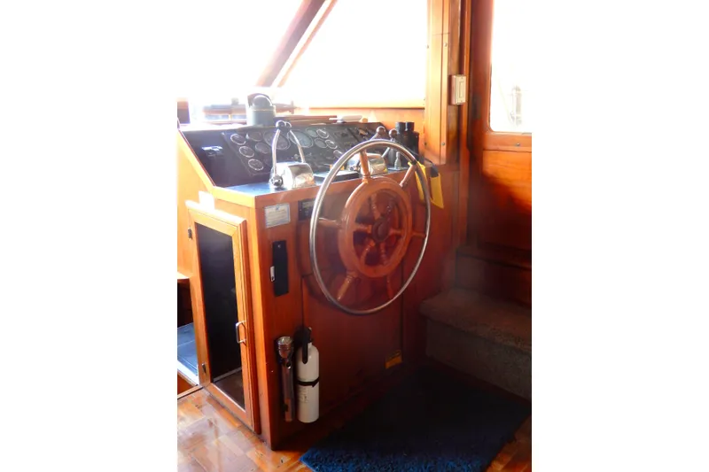 Slide: The Image of 1989 Jefferson 46 Sundeck helm with wooden steering wheel and control panel. - 32