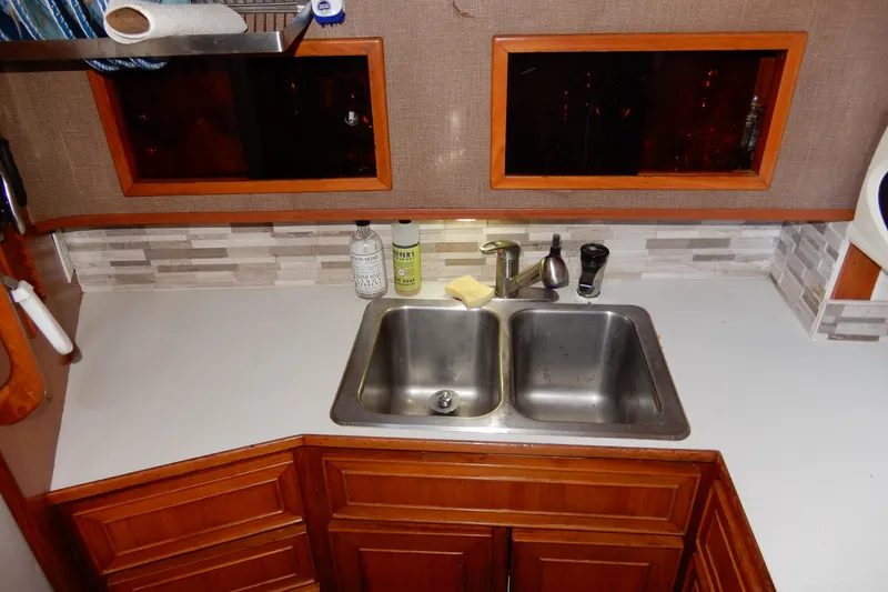 Slide: The Image of 1989 Jefferson 46 Sundeck kitchen with double sink and wooden cabinetry. - 37