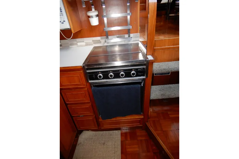 Slide: The Image of 1989 Jefferson 46 Sundeck yacht interior with stove and wooden cabinetry. - 38