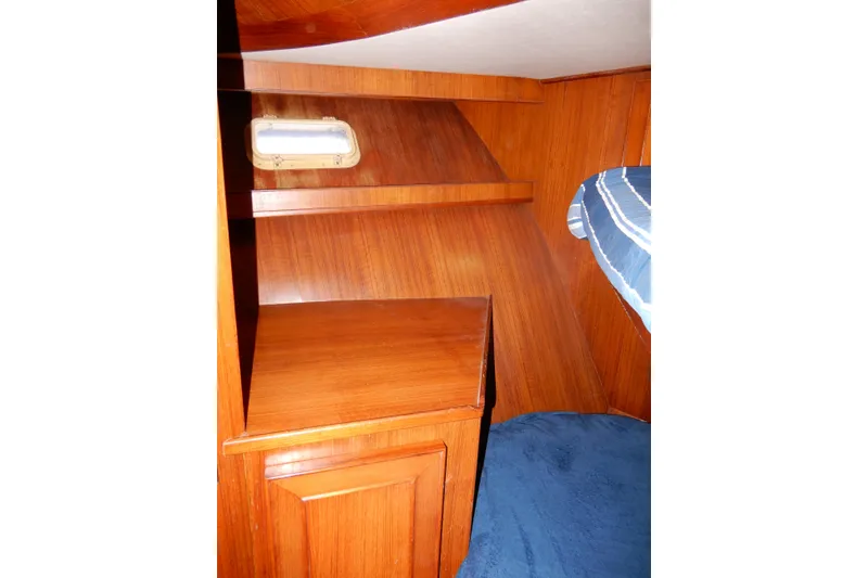 Slide: The Image of Interior of 1989 Jefferson 46 Sundeck yacht with wooden cabinetry and blue carpet. - 45