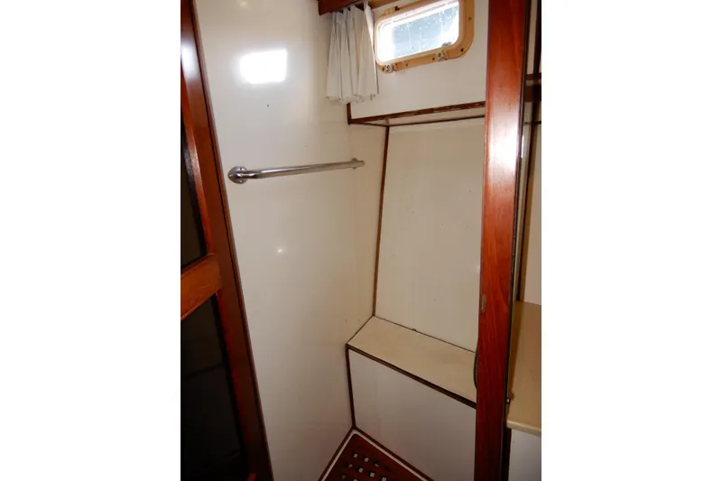 Slide: The Image of 1989 Jefferson 46 Sundeck interior shower area with wooden accents and small window. - 48
