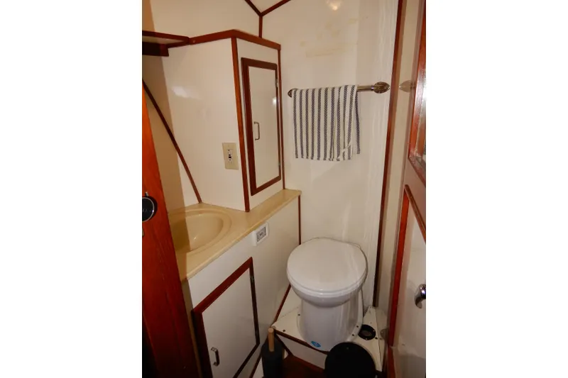 Slide: The Image of 1989 Jefferson 46 Sundeck bathroom with sink, toilet, and striped towel. - 49