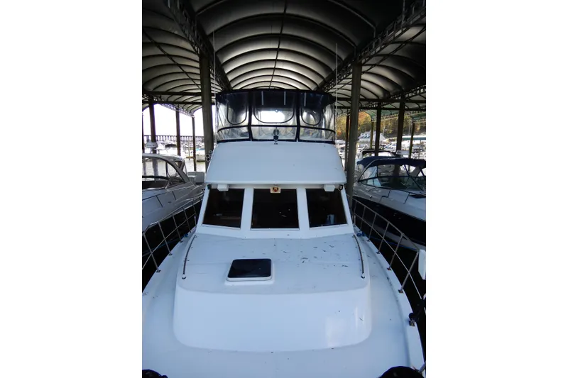 Slide: The Image of 1989 Jefferson 46 Sundeck yacht docked under covered marina. - 5