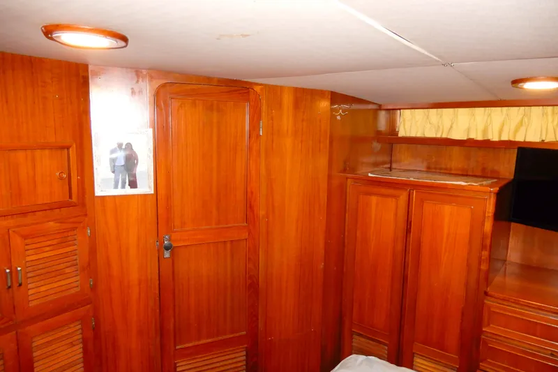 Slide: The Image of 1989 Jefferson 46 Sundeck interior with wooden cabinetry and cozy lighting. - 55